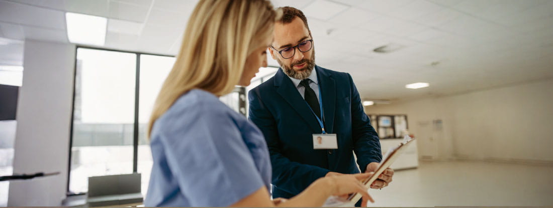 professional man talking to female healthcare professional